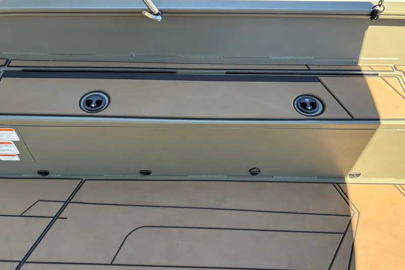 Slide: The Image of 2026 Tracker Grizzly 1756 T Marsh boat deck with storage compartments and rod holders. - 5