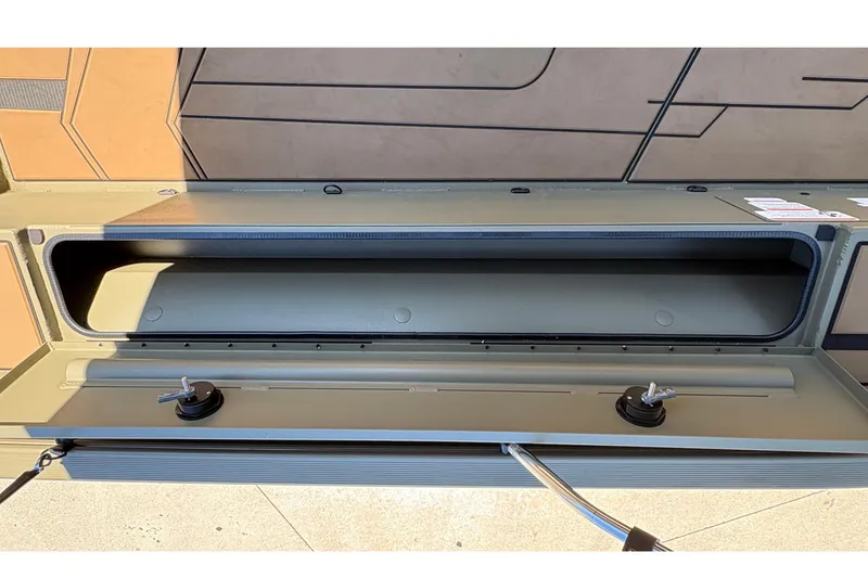 Slide: The Image of 2026 Tracker Grizzly 1756 T Marsh storage compartment, open lid, showcasing interior space. - 6