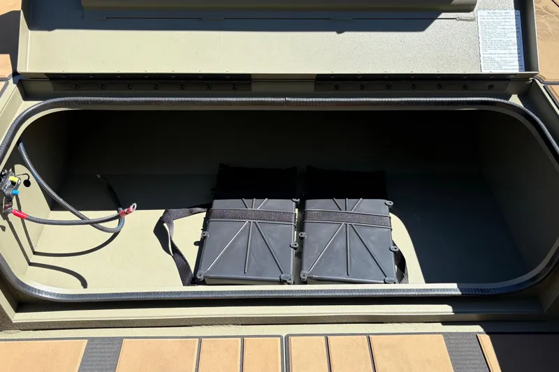 Slide: The Image of Storage compartment of 2026 Tracker Grizzly 1756 T Marsh boat with battery setup. - 4