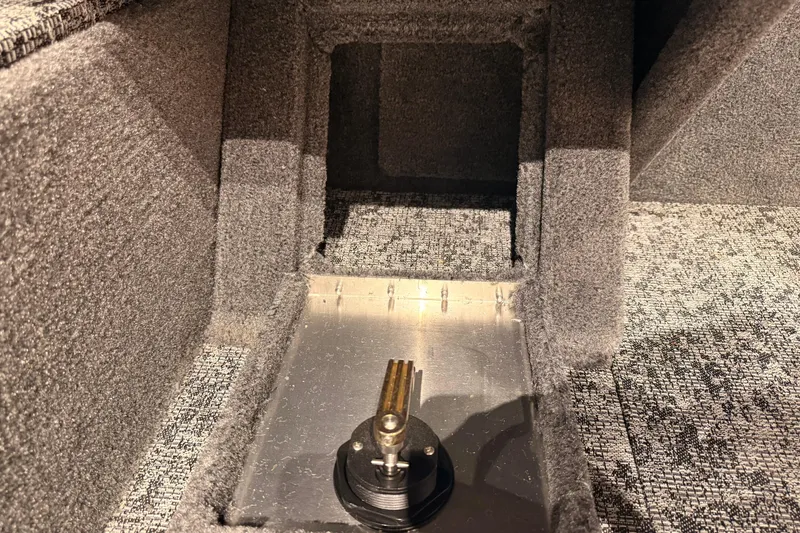 Slide: The Image of Interior view of 2026 Tracker Pro Guide V-16 WT boat, showcasing carpeted storage compartment. - 61