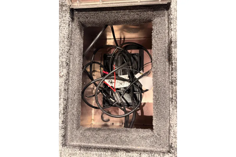 Slide: The Image of Interior view of 2026 Tracker Pro Guide V-16 WT boat compartment with wiring. - 57