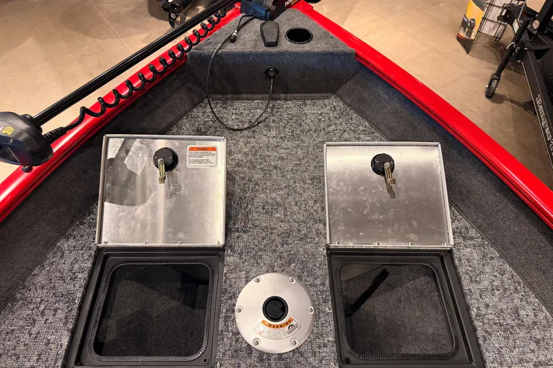 Slide: The Image of 2026 Tracker Pro Guide V-16 WT boat interior with storage compartments and red trim. - 53