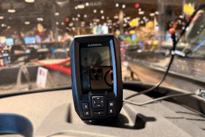 Slide: The Image of Garmin device on 2026 Tracker Pro Guide V-16 WT boat dashboard in showroom. - 50
