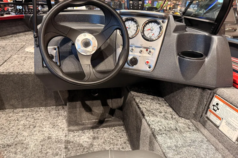 Slide: The Image of 2026 Tracker Pro Guide V-16 WT boat dashboard with steering wheel and instrument panel. - 59