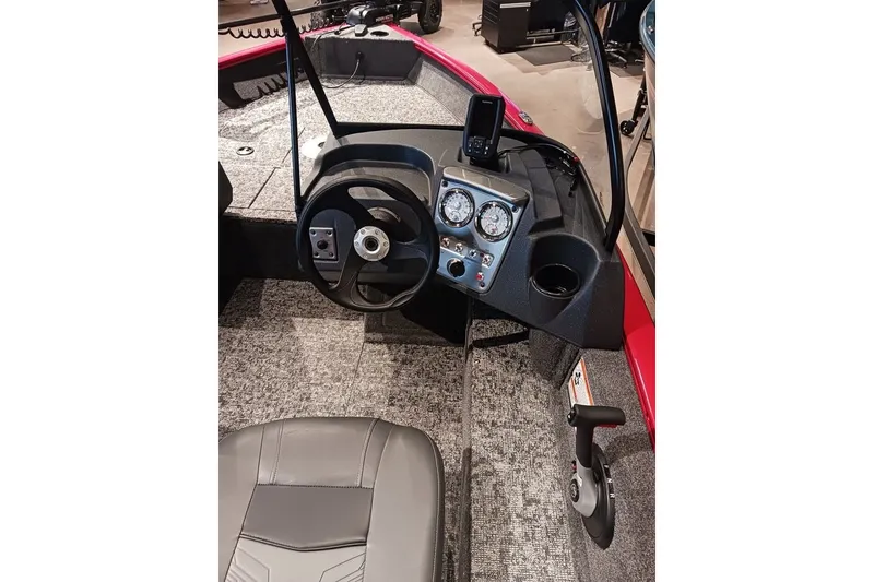 Slide: The Image of 2026 Tracker Pro Guide V-16 WT boat interior with steering wheel and dashboard controls. - 24
