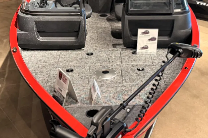 Slide: The Image of 2026 Tracker Pro Guide V-16 WT boat interior with red trim and fishing equipment. - 51