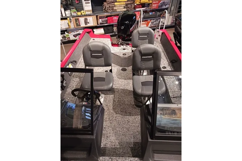 Slide: The Image of 2026 Tracker Pro Guide V-16 WT boat interior with seating and steering console. - 22