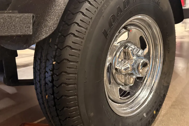 Slide: The Image of Close-up of a 2026 Tracker Pro Guide V-16 WT trailer tire and chrome wheel. - 47