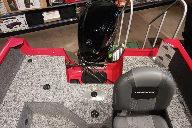 Slide: The Image of 2026 Tracker Pro Guide V-16 WT boat interior with motor and seating. - 23