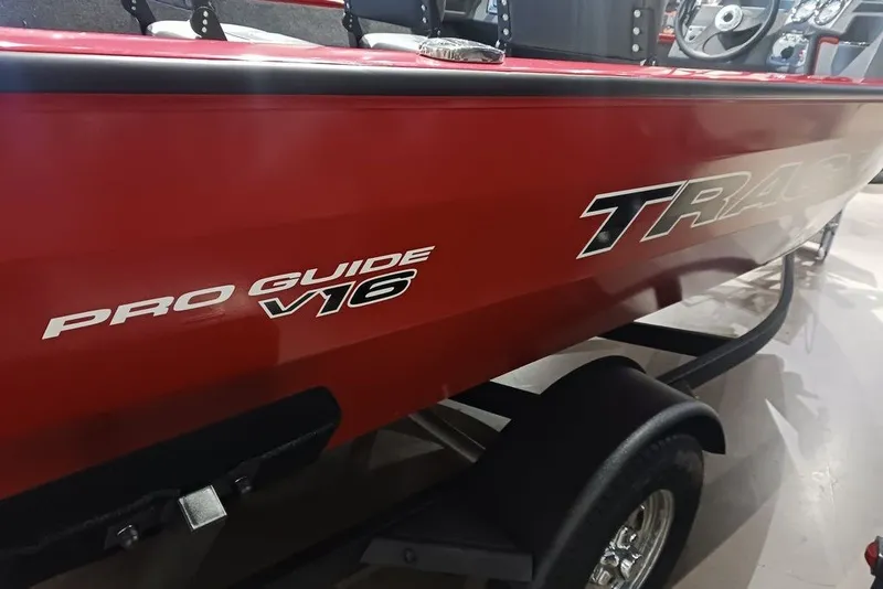 Slide: The Image of 2026 Tracker Pro Guide V-16 WT boat in vibrant red on trailer. - 28