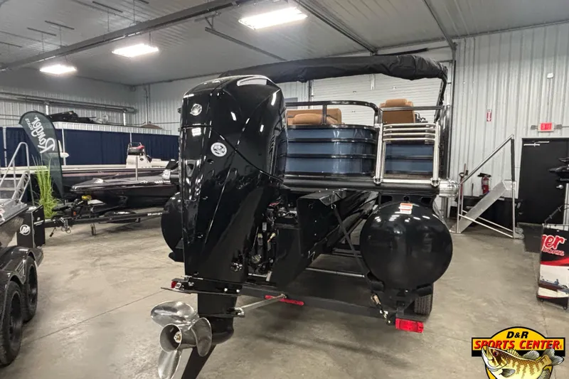 Slide: The Image of 2026 Ranger 223FC boat displayed indoors with powerful outboard motor. - 4