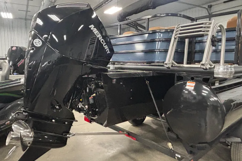 Slide: The Image of 2026 Ranger 223FC boat with Mercury outboard motor in a showroom. - 5