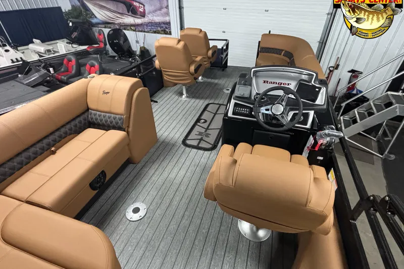 Slide: The Image of Interior of 2026 Ranger 223FC boat with tan seating and modern steering console. - 8
