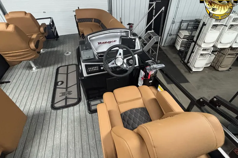 Slide: The Image of 2026 Ranger 223FC boat interior with tan seating and modern dashboard controls. - 9