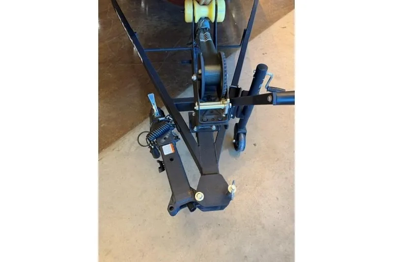 Slide: The Image of 2026 Tracker Panfish 17 trailer hitch and winch mechanism on concrete floor. - 11