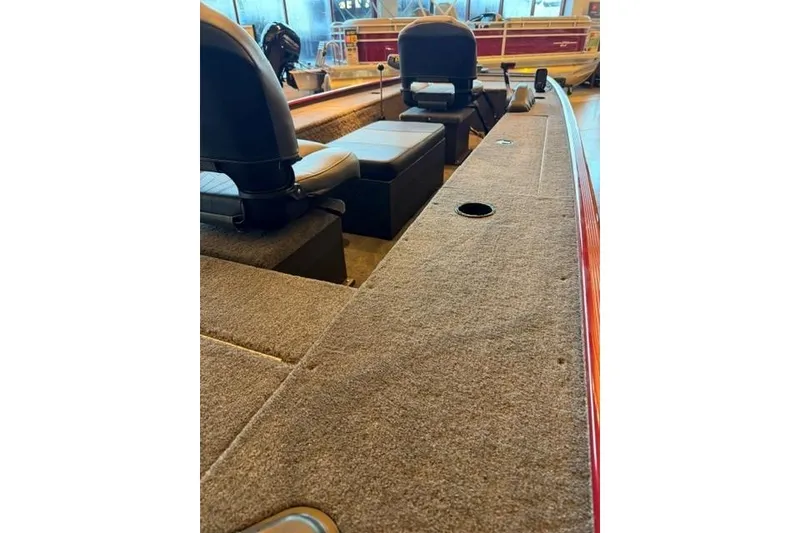 Slide: The Image of 2026 Tracker Panfish 17 boat interior with seating and carpeted deck. - 6
