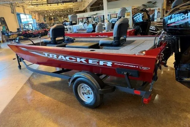 The Image of 2026 Tracker Panfish 17 boat in showroom, red exterior, dual seats, trailer attached. - 0