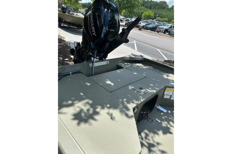 Slide: The Image of 2026 Tracker Grizzly 1654 T Sportsman boat with Mercury engine in parking lot. - 4