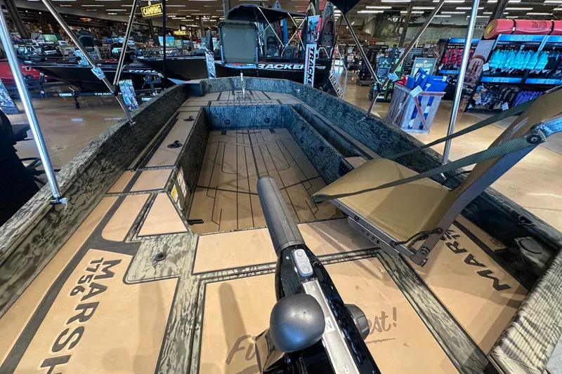 Slide: The Image of 2026 Tracker Grizzly 1756 T Marsh boat interior, showcasing seating and deck layout in showroom. - 40