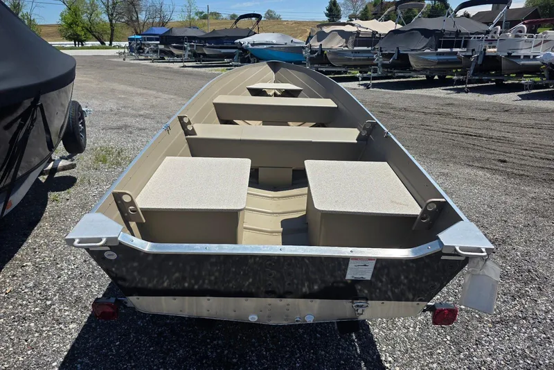 Slide: The Image of 2026 Smoker Craft Voyager 16 boat on display in a marina lot. - 4
