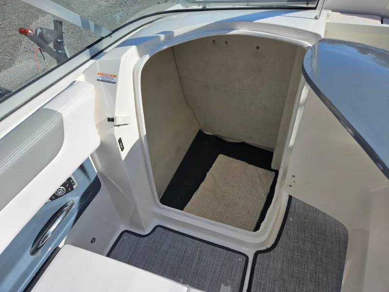 Slide: The Image of Interior of 2020 Chaparral 230 Suncoast boat with carpeted flooring. - 14