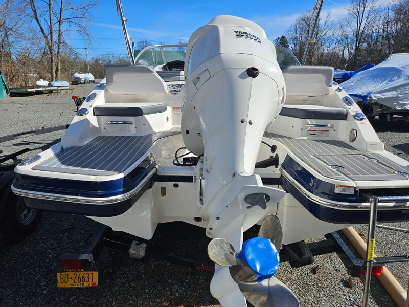 Slide: The Image of Rear view of a 2020 Chaparral 230 Suncoast boat with outboard motor. - 2