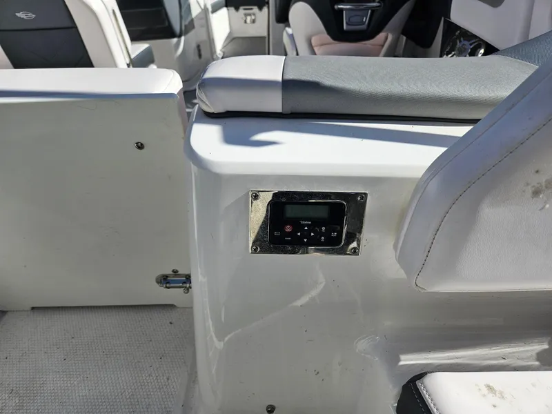 Slide: The Image of Interior of a 2020 Chaparral 230 Suncoast boat with control panel. - 26