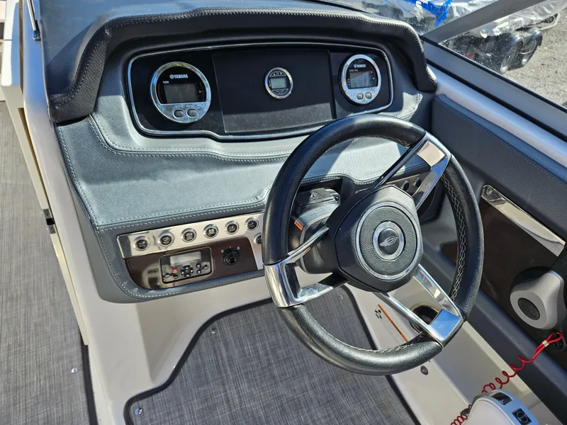 Slide: The Image of Steering wheel and dashboard of a 2020 Chaparral 230 Suncoast boat. - 5