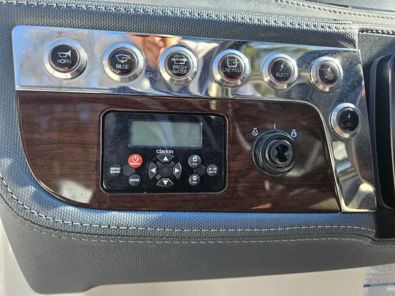 Slide: The Image of Dashboard of 2020 Chaparral 230 Suncoast with controls and radio. - 6