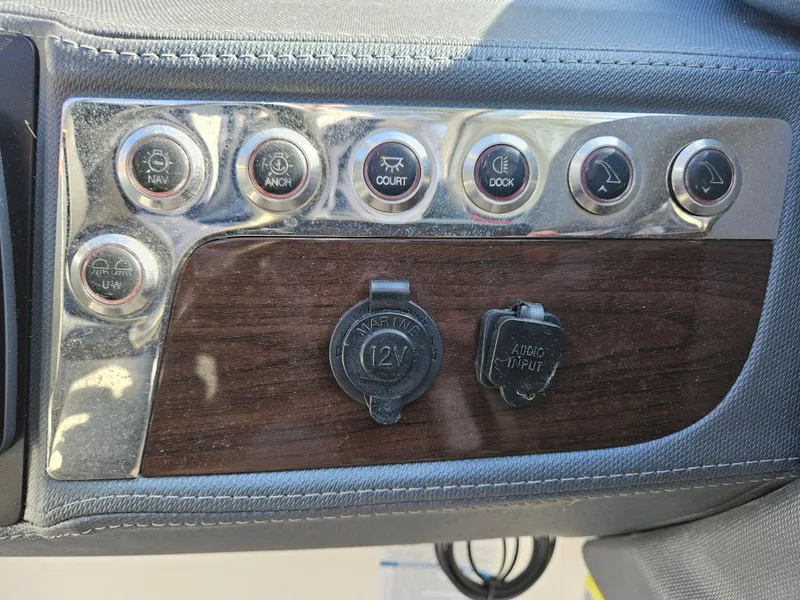 Slide: The Image of Dashboard of 2020 Chaparral 230 Suncoast with switches and outlets. - 7