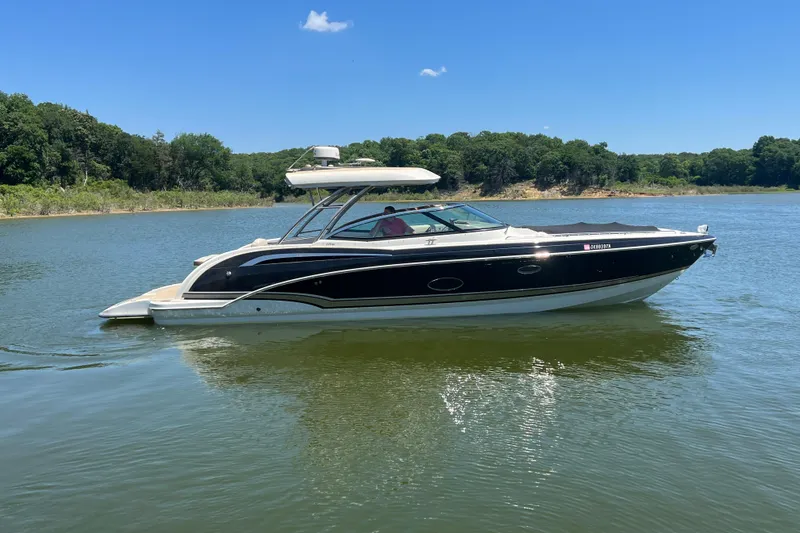 The Image of 2014 Formula 350 Crossover Bowrider I/O on a serene lake with lush green shoreline. - 0