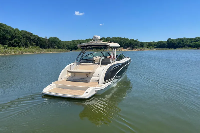 Slide: The Image of 2014 Formula 350 Crossover Bowrider I/O on a serene lake under clear blue skies. - 11