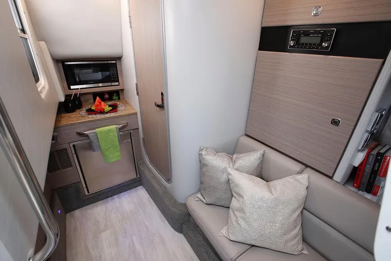 Slide: The Image of Manufacturer Provided Image: Interior of 2021 Formula 350 Crossover Bowrider I/O with kitchenette and seating area. - 17