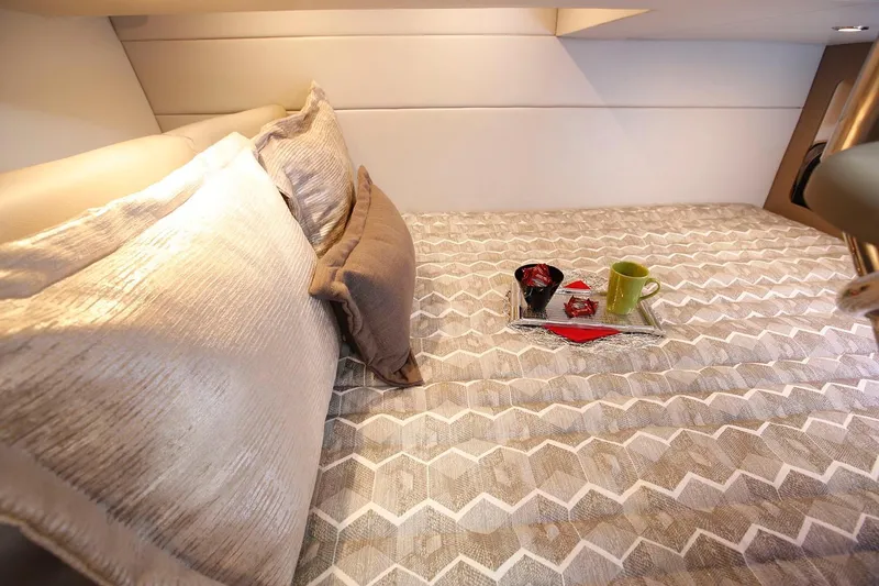 Slide: The Image of Manufacturer Provided Image: Cozy cabin bed in 2021 Formula 350 Crossover Bowrider I/O with pillows and breakfast tray. - 19