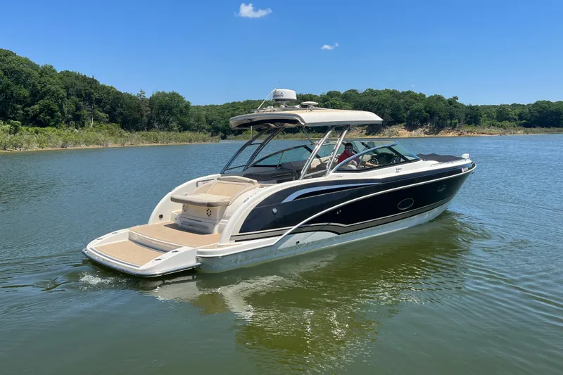Slide: The Image of 2014 Formula 350 Crossover Bowrider I/O cruising on a serene lake. - 5
