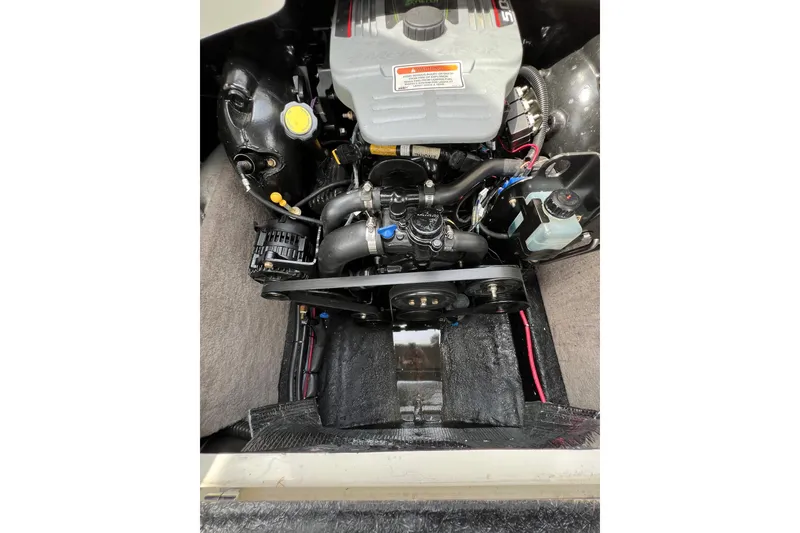 Slide: The Image of Engine compartment of a 2014 Stingray 250 LR boat, showcasing mechanical components. - 10