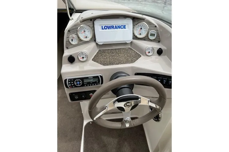 Slide: The Image of 2014 Stingray 250 LR boat dashboard with Lowrance display and steering wheel. - 4
