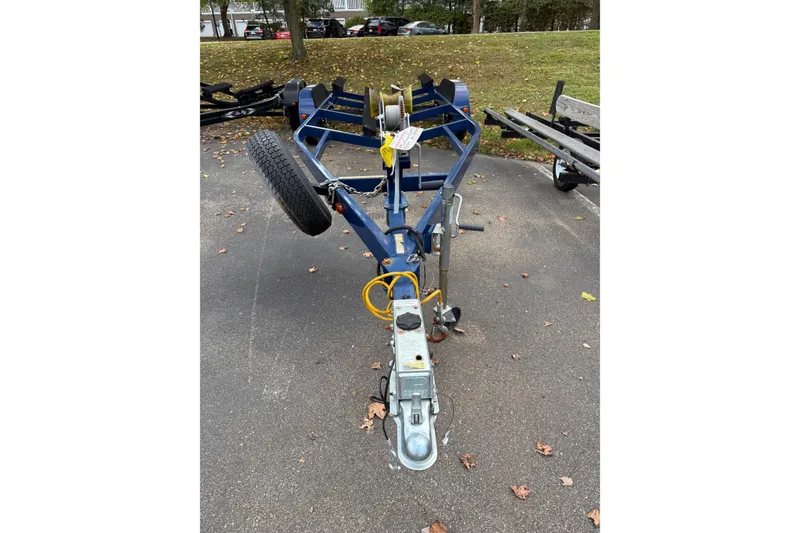 Slide: The Image of Trailer for 2014 Stingray 250 LR boat parked on asphalt with fallen leaves. - 9