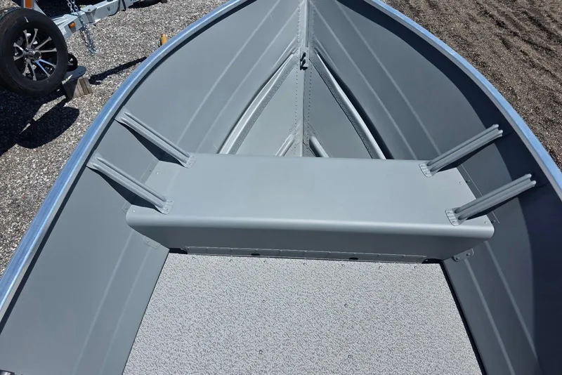 Slide: The Image of 2026 Smoker Craft Alaskan 15 TS DLX boat interior with gray seating and flooring. - 5