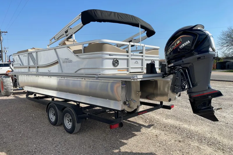 Slide: The Image of 2026 SunCatcher Elite 324 SS pontoon boat with Yamaha engine on trailer. - 4