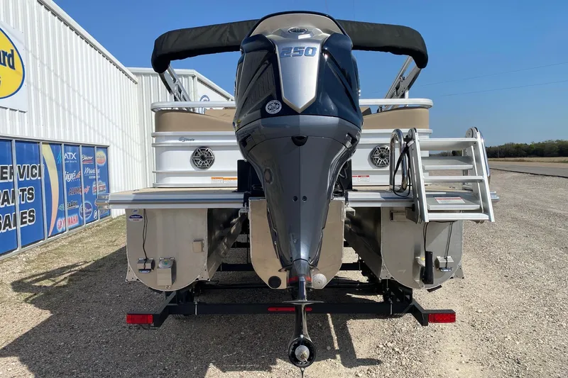 Slide: The Image of 2026 SunCatcher Elite 324 SS pontoon boat with powerful outboard motor, parked outdoors. - 5
