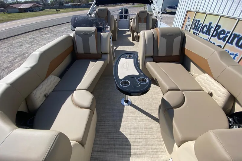 Slide: The Image of Luxurious interior of 2026 SunCatcher Elite 324 SS pontoon boat with plush seating and table. - 7