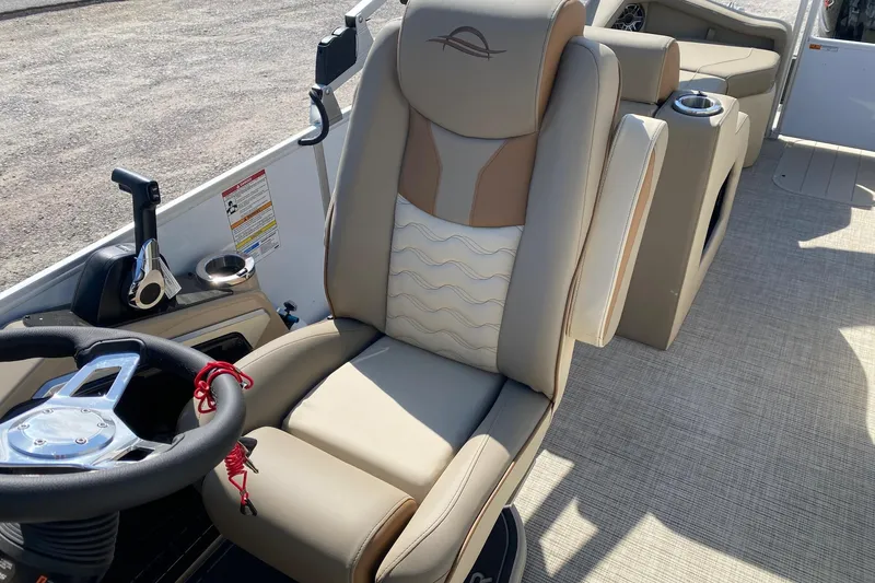 Slide: The Image of Luxury seating and steering area of 2026 SunCatcher Elite 324 SS boat. - 9