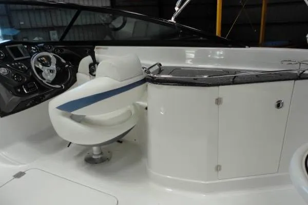 Slide: The Image of 2015 Monterey 264FS boat interior with steering wheel and seating area. - 11