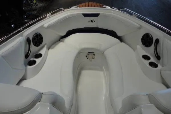 Slide: The Image of 2015 Monterey 264FS boat interior with white seating and cup holders. - 13