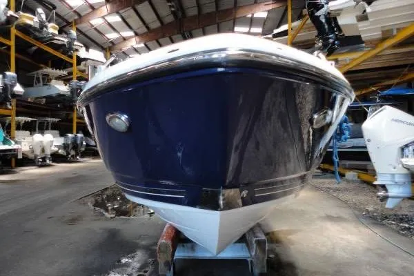 Slide: The Image of 2015 Monterey 264FS boat in storage, showcasing sleek blue hull design. - 5