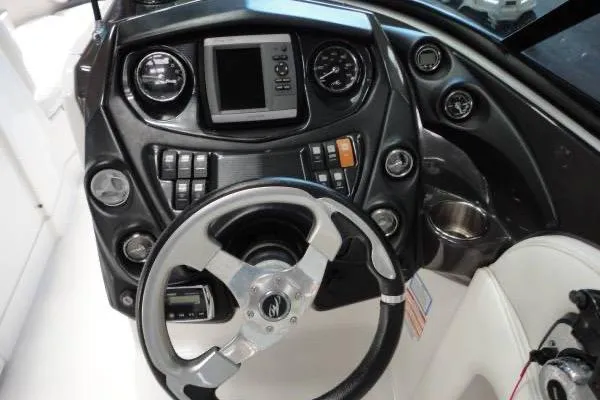 Slide: The Image of Steering console of a 2015 Monterey 264FS boat with gauges and controls. - 9