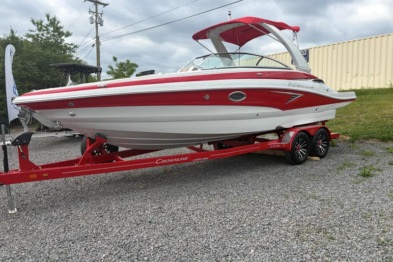 Slide: The Image of 2026 Crownline 278 SS boat in red and white on a matching trailer. - 2