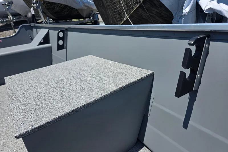 Slide: The Image of 2026 Smoker Craft Alaskan 15 TS DLX boat interior with storage compartment and rod holder. - 7
