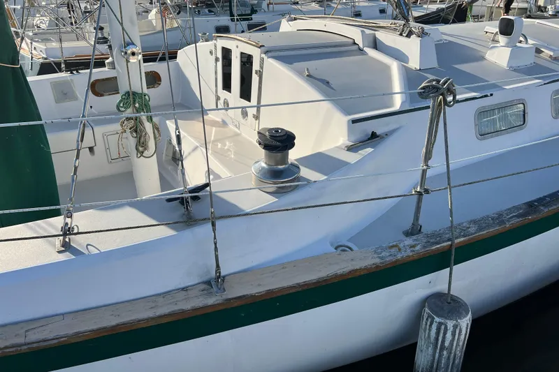 Slide: The Image of 1979 Pearson 424 sailboat docked, showcasing deck and rigging details. - 16
